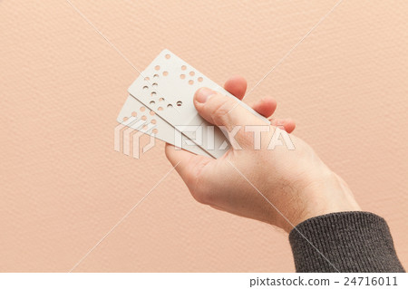 Male hand holds plastic door key cards 24716011