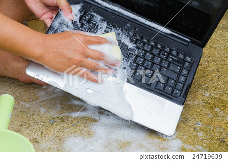 cleaning computer notebook with dish washing soap 24719639