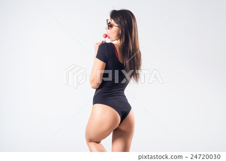 Young brunette model with lollipop studio shot on Young brunette model with lollipop studio shot on 24720030