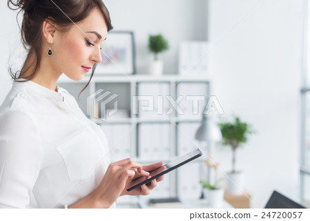 Portrait of an office manager holding her tablet 24720057