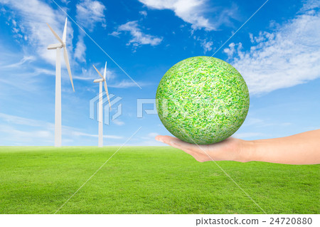 green grass field with wind turbine and hand 24720880