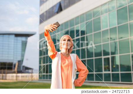 muslim woman taking selfie muslim woman taking selfie 24722715