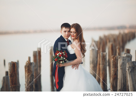 Wedding couple, groom, bride with bouquet posing Wedding couple, groom, bride with bouquet posing 24727025