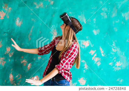 Woman in virtual reality helmet. VR glasses. Woman in virtual reality helmet. VR glasses. 24728848