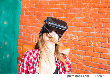 Girl with pleasure uses head-mounted display 24728980