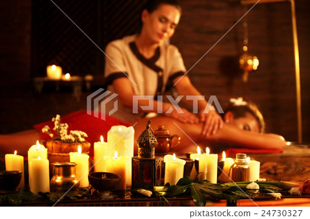 Woman lying on wooden massage spa bed. Woman lying on wooden massage spa bed. 24730327