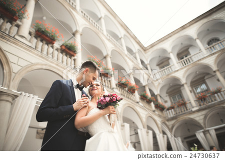 Lovely happy wedding couple, bride with long white 24730637