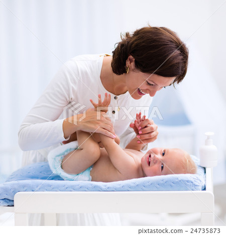 Mother and baby on changing table 24735873