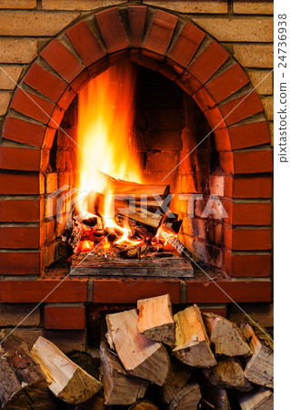 woods pile and burning firewood in brick fireplace 24736938
