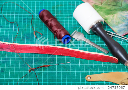 sewing tools and stitching chisel on mat 24737067