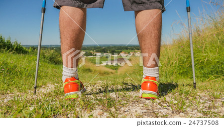 Man walking on sidewalk, sport shoes 24737508