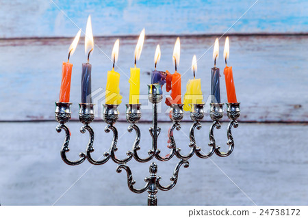 Hanukkah menorah with candles and silver dreidel. Hanukkah menorah with candles and silver dreidel. 24738172