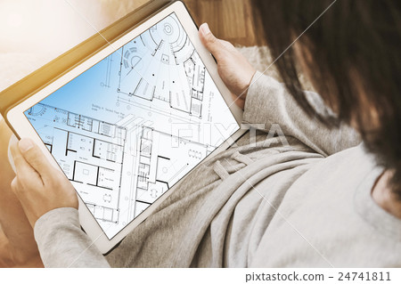 Asian guy using digital tablet in living room 24741811