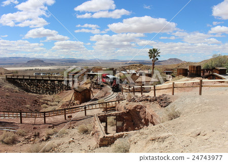 A steam locomotive running in a ghost town of a waste pit trace America A steam locomotive running in a ghost town of a waste pit trace America 24743977