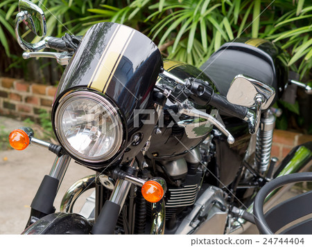 Motorbikes are large and black, vintage style . Motorbikes are large and black, vintage style . 24744404