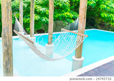 White hammocks in Luxury swimming pool . 24745718