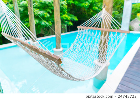 White hammocks in Luxury swimming pool . 24745722