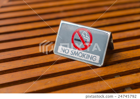 NO Smoking sign on wood table . NO Smoking sign on wood table . 24745792