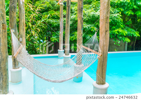White hammocks in Luxury swimming pool . 24746632
