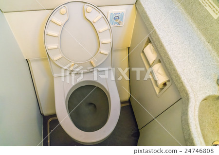 Aircraft lavatory toilets aboard a jetliner airplane . 24746808