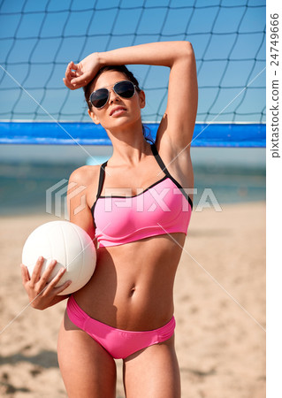 young woman with volleyball ball and net on beach young woman with volleyball ball and net on beach 24749666