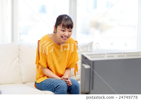 happy asian young woman watching tv at home 24749778