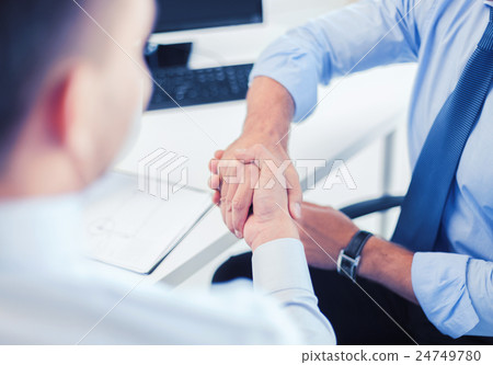 businessmen shaking hands in office 24749780
