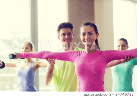 group of smiling people working out with dumbbells 24749782