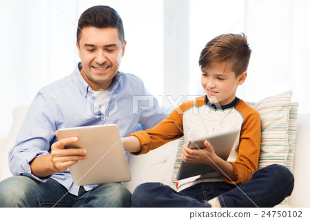 happy father and son with tablet pc at home 24750102