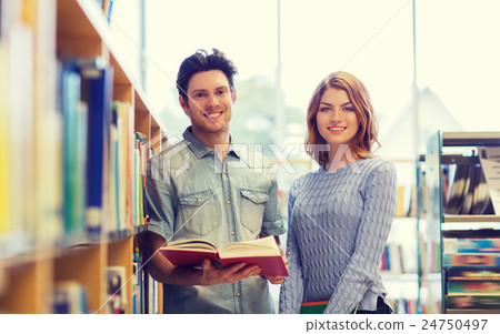 happy student couple with books in library happy student couple with books in library 24750497