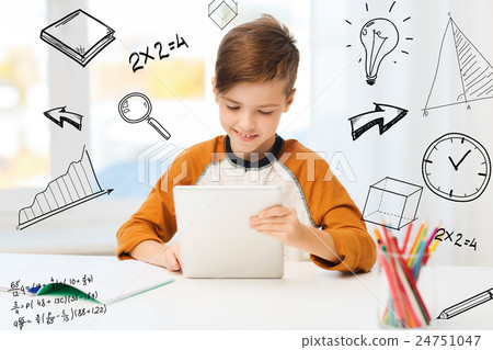 smiling boy with tablet pc and notebook at home 24751047
