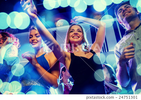 smiling friends dancing in club 24751301