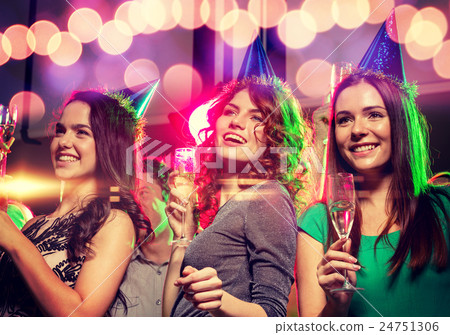 smiling friends with glasses of champagne in club 24751306