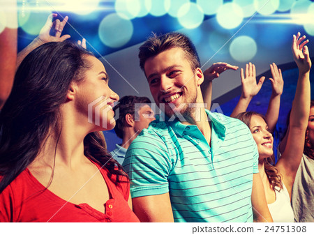 smiling friends at concert in club 24751308