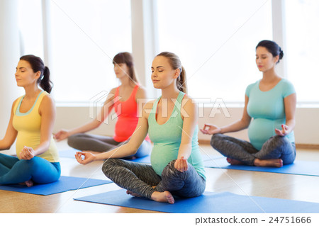 happy pregnant women exercising yoga in gym happy pregnant women exercising yoga in gym 24751666