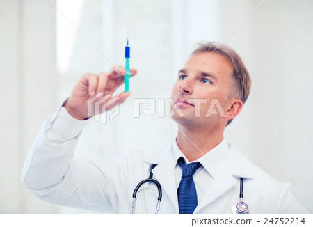 male doctor holding syringe with injection 24752214
