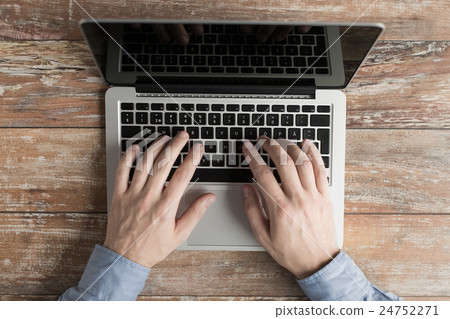 Stock Photo: close up of male hands with laptop typing