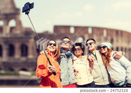happy friends with smartphone selfie stick 24752328