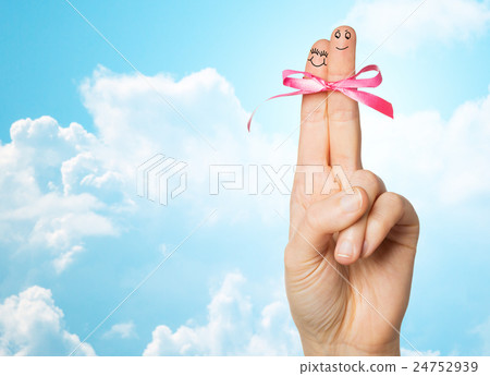 close up of two fingers tied by pink bow knot close up of two fingers tied by pink bow knot 24752939
