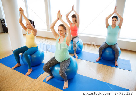 happy pregnant women exercising on fitball in gym happy pregnant women exercising on fitball in gym 24753158