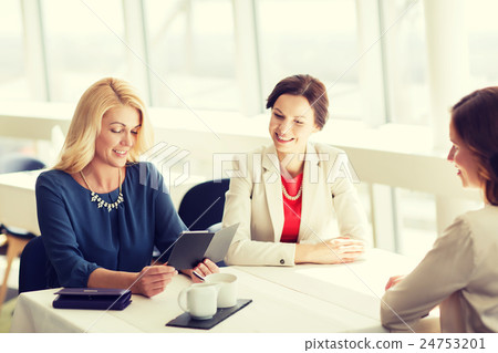 happy women looking at restaurant bill 24753201