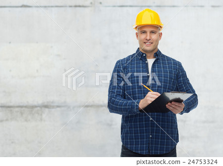smiling male builder in helmet with clipboard smiling male builder in helmet with clipboard 24753324