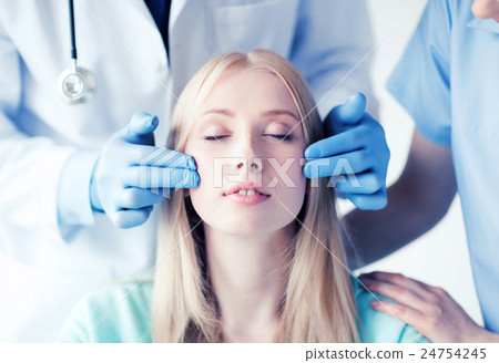 plastic surgeon and nurse with patient plastic surgeon and nurse with patient 24754245