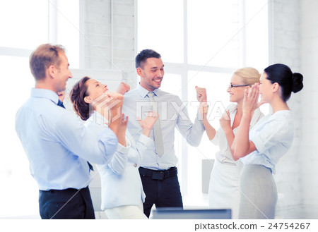 business team celebrating victory in office business team celebrating victory in office 24754267