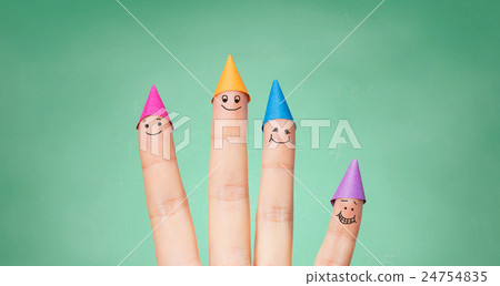 close up of hand with four fingers in party hats close up of hand with four fingers in party hats 24754835