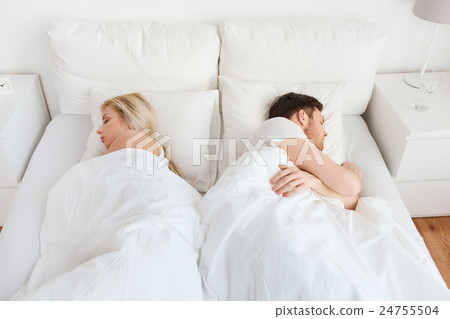 couple sleeping in bed at home 24755504