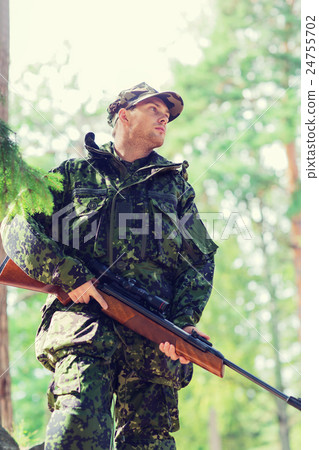 young soldier or hunter with gun in forest 24755702