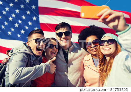 smiling friends taking selfie with smartphone 24755795