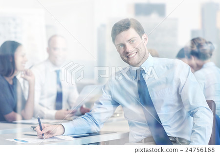 group of smiling businesspeople meeting in office 24756168