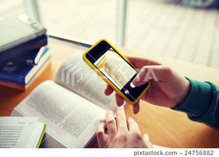 student hands with smartphone making cheat sheet student hands with smartphone making cheat sheet 24756882
